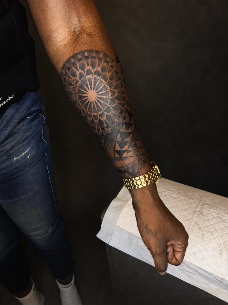Geometric mandala tattoo on the forearm