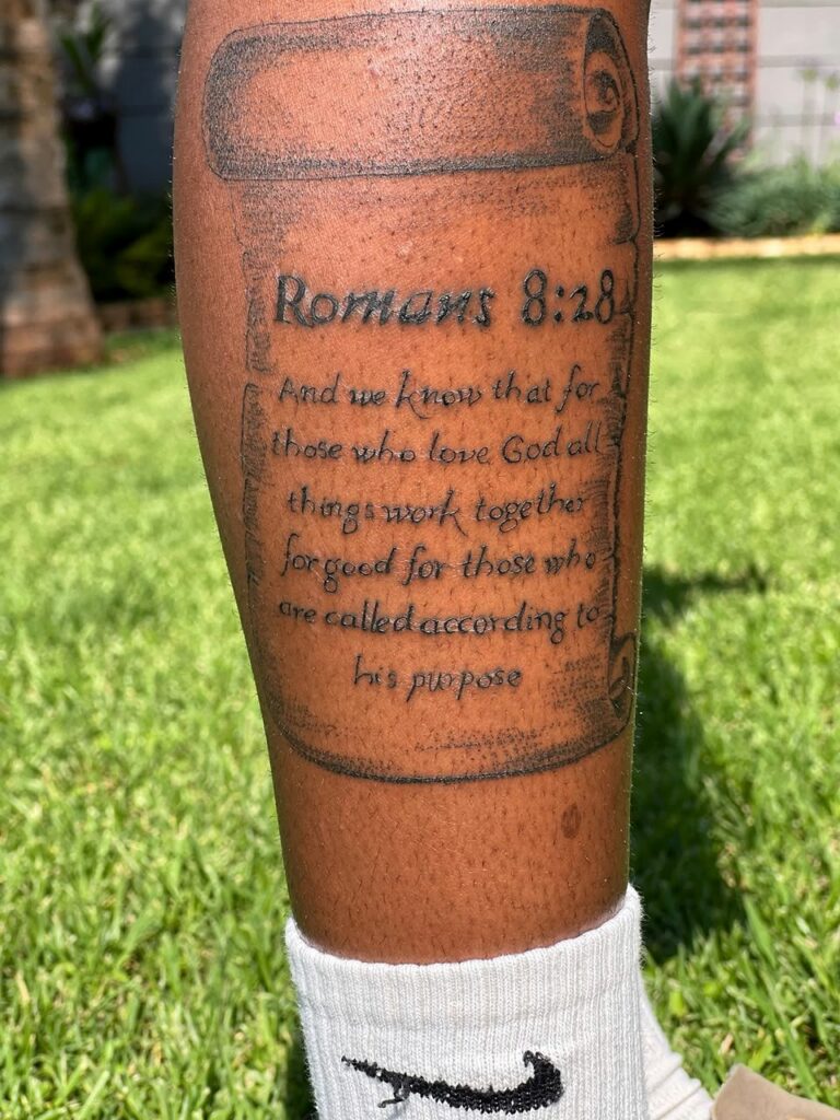 Bible verse scroll tattoo on the lower leg