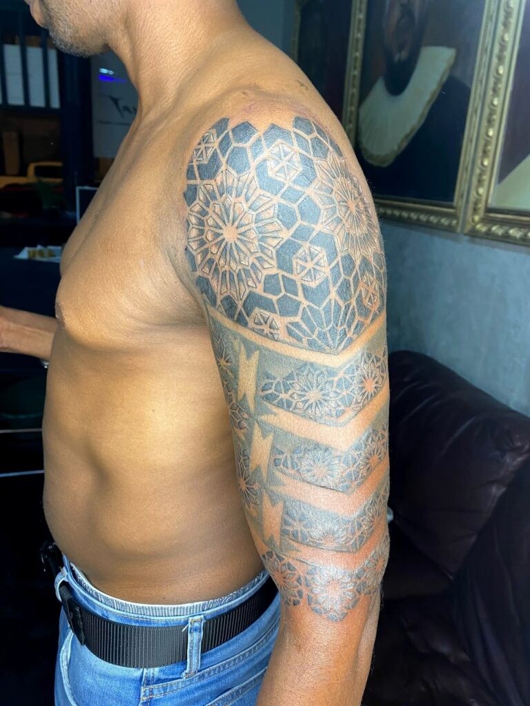 Geometric mandala shoulder and upper-arm tattoo